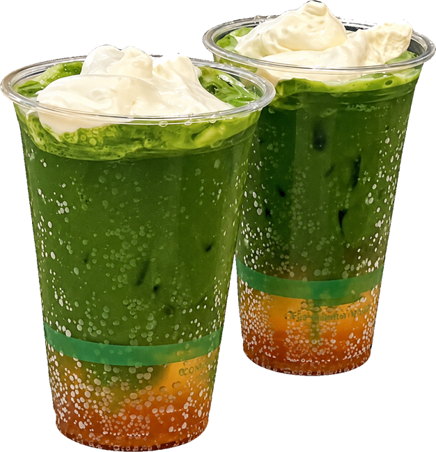 Two iced matcha tonics topped with whipped cream